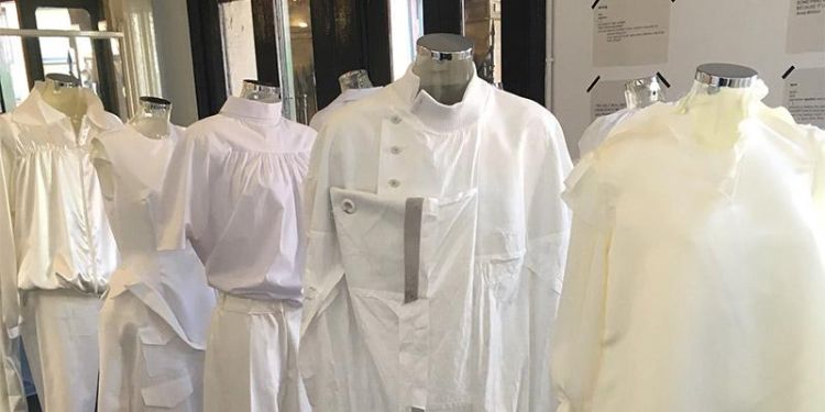 Line up of mannequins dressed in white clothing in various styles