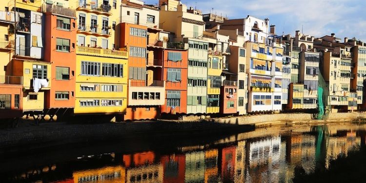 Street of houses and water reflection in Spain