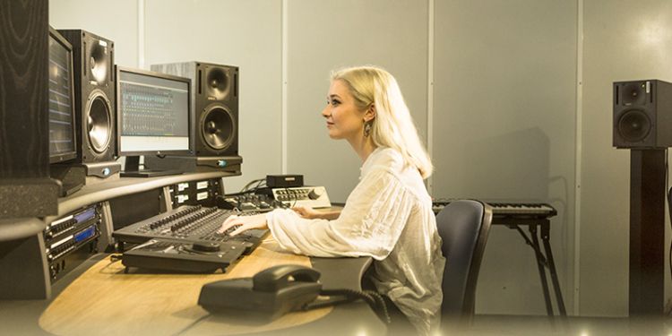 Student using music editing equipment and software