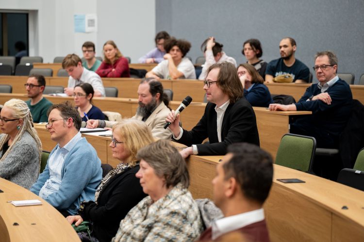 Man in the lecture audience asks a question