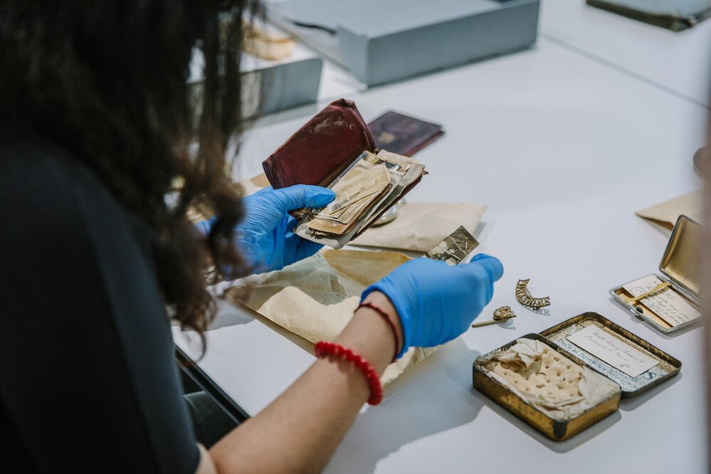 pic of someone in gloves examining rare works
