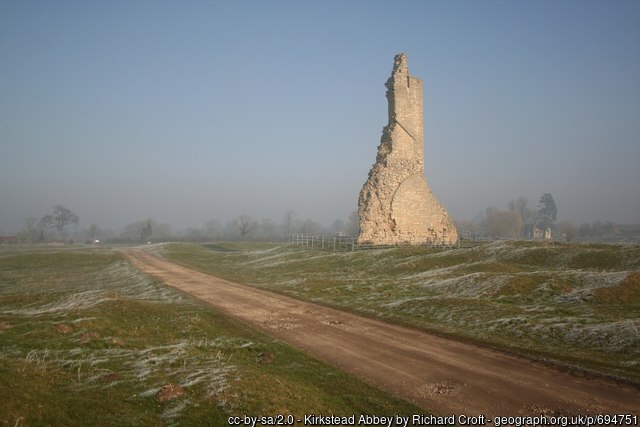 Ruined medieval wall against a blue sky on a frosty morning.
