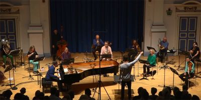 A group of musicians playing in a concert in the School of Music