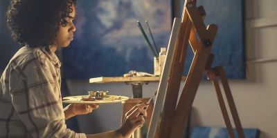 Woman artist painting at an easel
