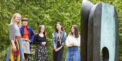 Group of student interns with the Hepworth sculpture on campus.