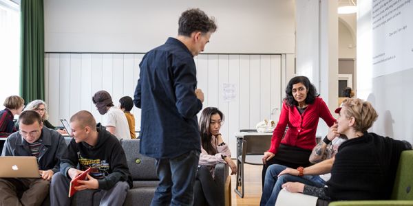 Students and staff in common area of FAHACS building