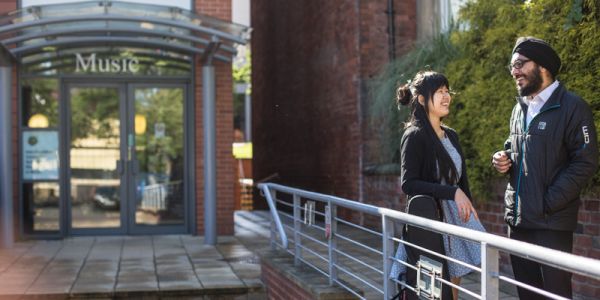 Two students outside of the School of Music entrance