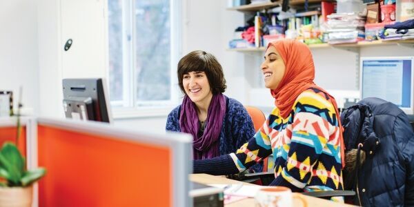 Student and mentor at a desk.