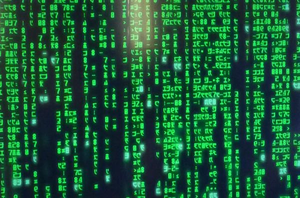 Vertical columns of green binary code descending over a black screen