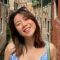 Student Steph Boon smiling in front of a variety of buildings.