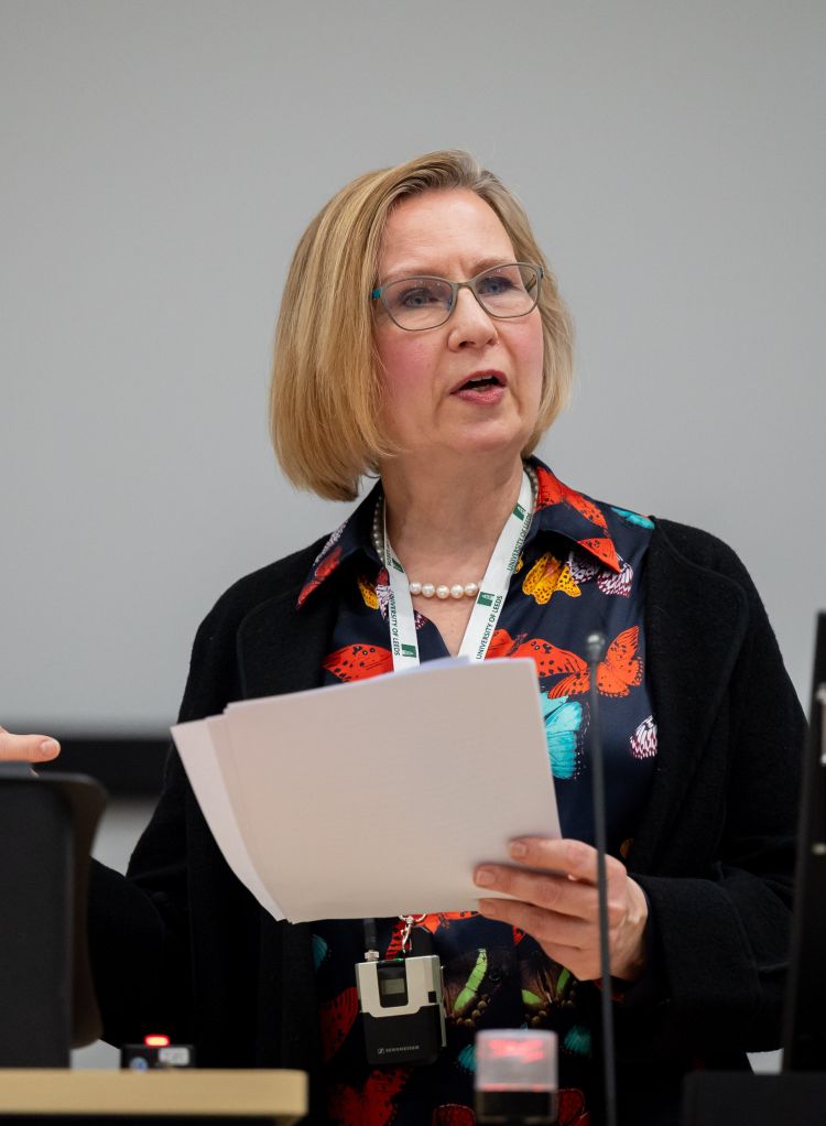 Claudia Rapp at the front of a theatre delivering her lecture