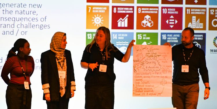 Four researchers deliver a talk at the mental health conference