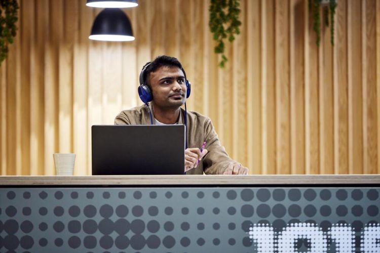 Student sitting in a cafe with laptop.