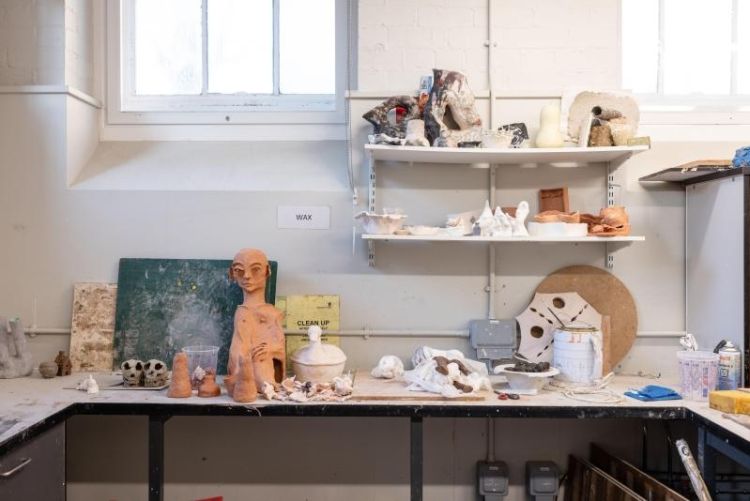Casting workshop in the School of Fine Art, History of Art and Cultural Studies featuring student work-in-progress pieces on tables and shelves
