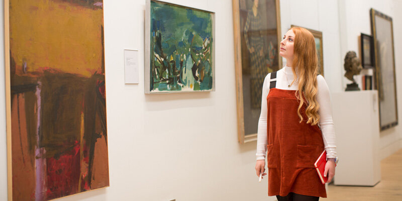 Student looking at artwork in gallery
