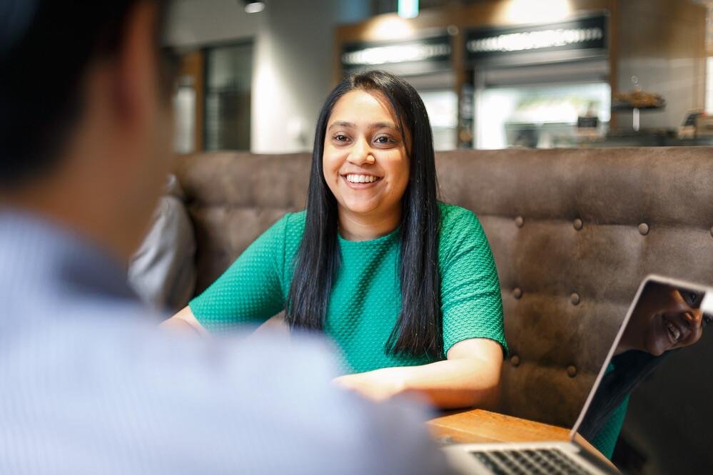 Student smiling and talking.